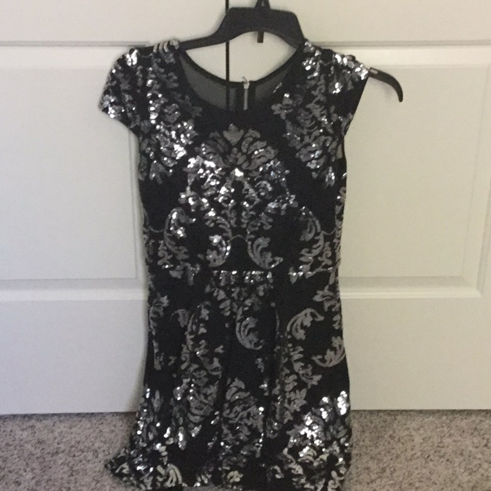 Fully lined Black with silver appliqués. Fancy